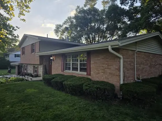 Freshly installed white seamless gutters