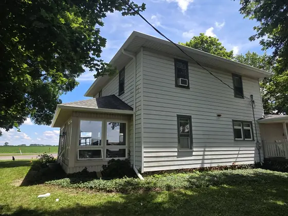 Two-storey farmhouse with new white seamless gutters