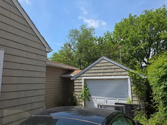 Two-storey home and detached garage with new gutters